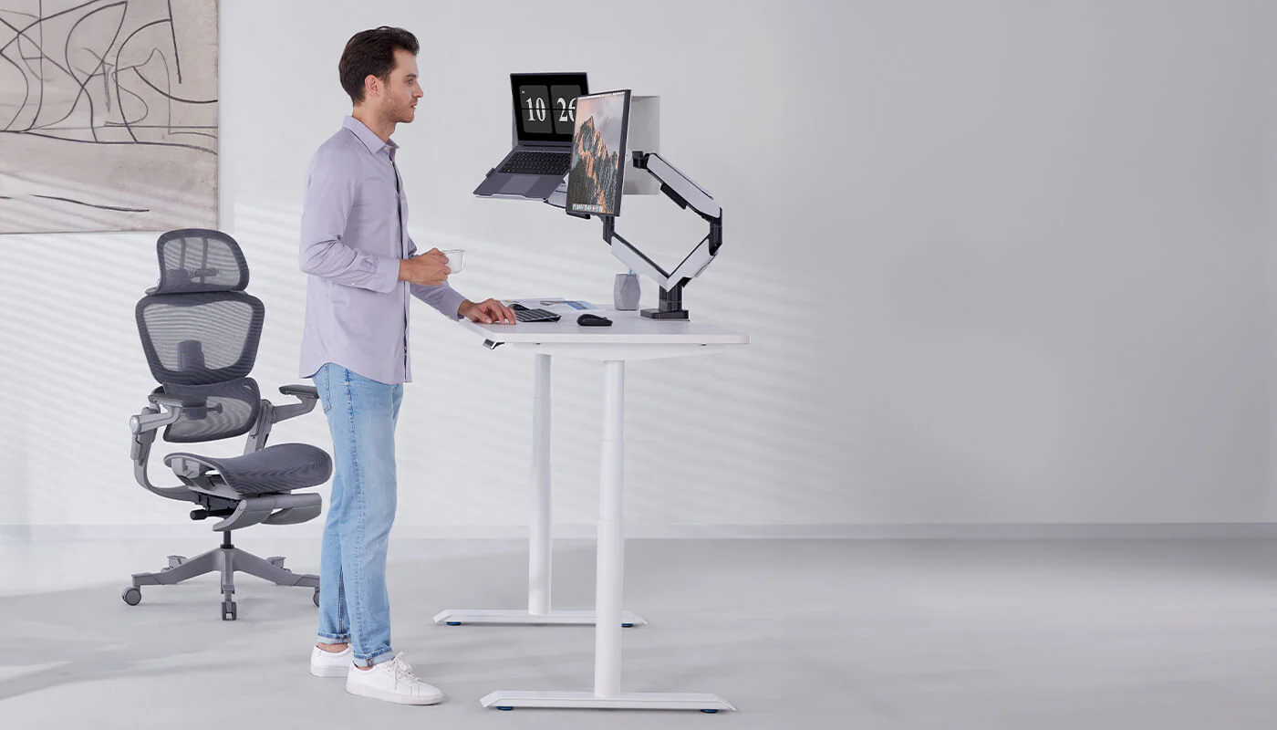 Person at a standing desk pausing for a brief movement break during a structured work session